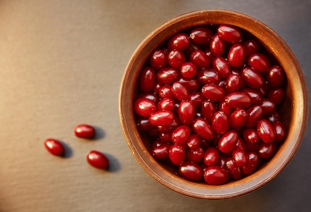 Natural healthy dogwood berry in the clay bowl Autumn healthy food Healthy vitamins organic food