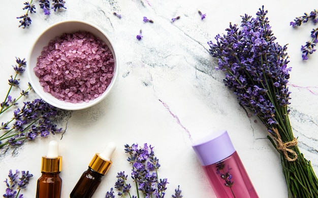 Natural herb cosmetic with lavender,  flatlay on white marble surface,  top view