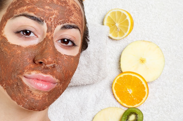 natural homemade fruit facial masks. fresh fruit. spa woman applying facial cleansing mask