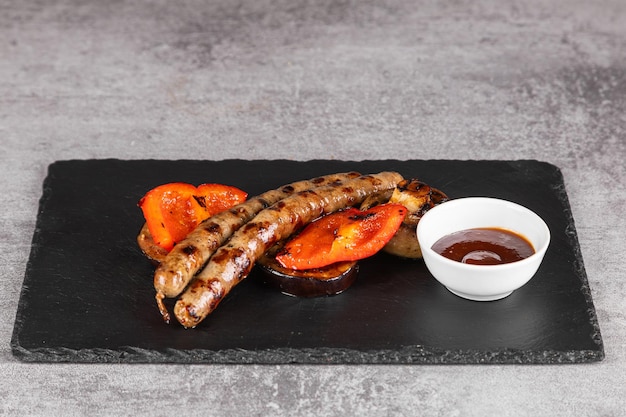 Natural homemade sausages and vegetables red peppers grilled selective focus