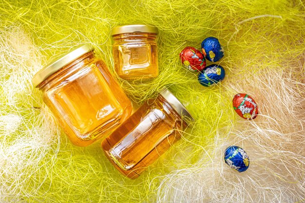 Natural honey in various jars on a wooden shelf souvenir village market