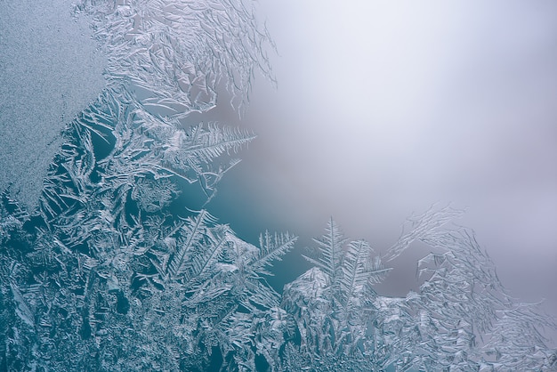 Photo natural ice crystals frostwork on the window, space for text.