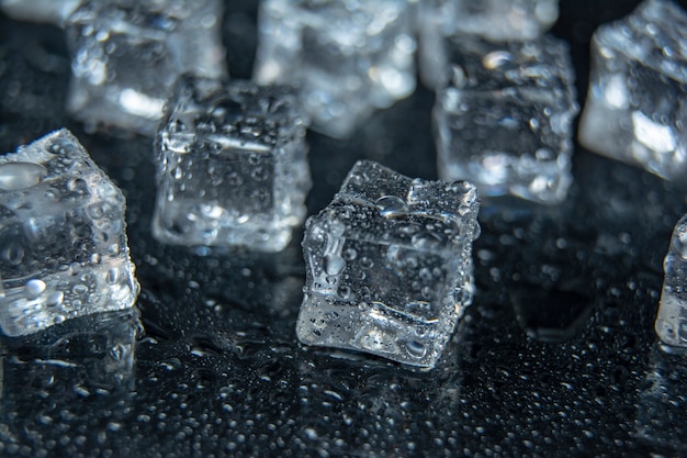 Natural ice cubes on black background, isolated on black. Pieces of ice on a black background, ice, cold