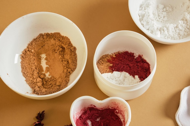 Natural ingredients for powder DIY cosmetics hibiscus blush turmeric starch and hibiscus petal powder mix