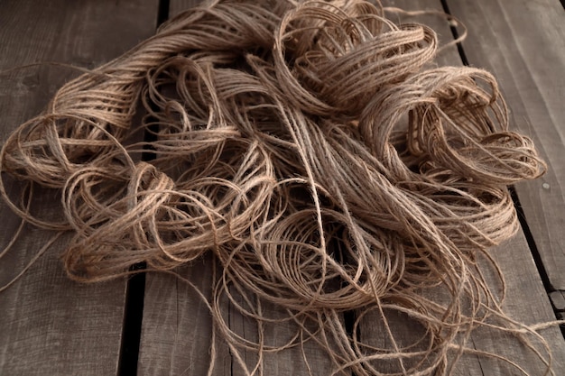 Natural jute yarn on rustic wooden background