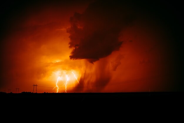 Natural lightning bolt strike in orange sky.