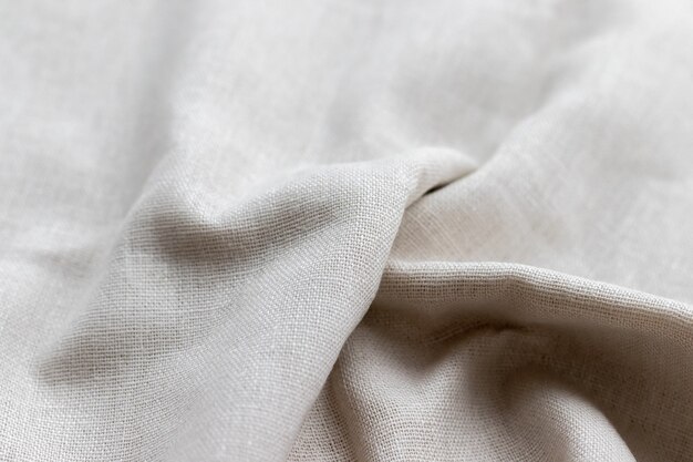 Photo natural linen fabric texture. rough crumpled burlap background. selective focus. closeup view