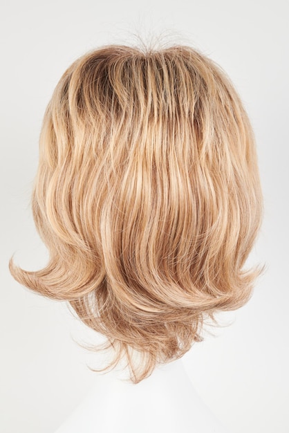 natural looking blonde fair wig on white mannequin head short hair cut on the plastic wig holder isolated on white background back view