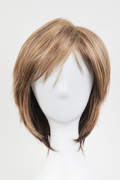 Foto parrucca brunet scura dall'aspetto naturale su testa di manichino bianco capelli castani corti sul supporto per parrucca in plastica isolato su sfondo bianco vista frontale