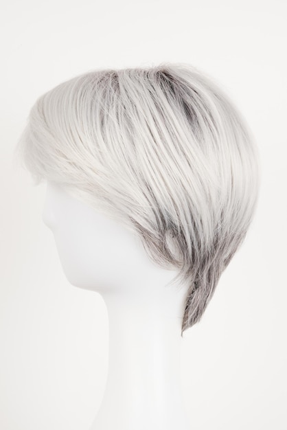 Natural looking silver blonde wig on white mannequin head Short hair on the plastic wig holder isolated on white background side view