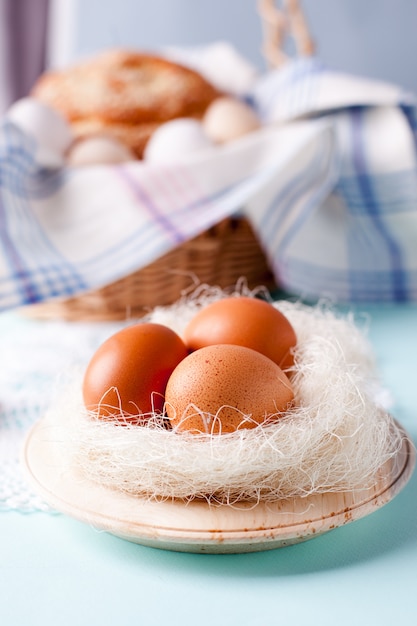 natural materials and unpainted organic eggs on a wicker basket 