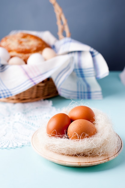 natural materials and unpainted organic eggs on a wicker basket 