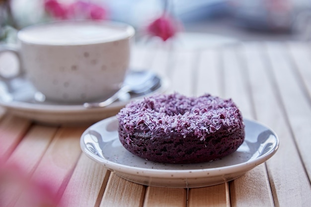 Natural no sugar doughnut and cappuccino at the terrace in the cafe Aesthetic coffee time outside