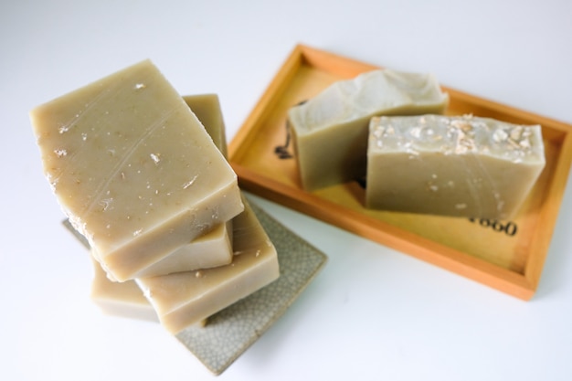 Natural oatmeal soap is placed on white 