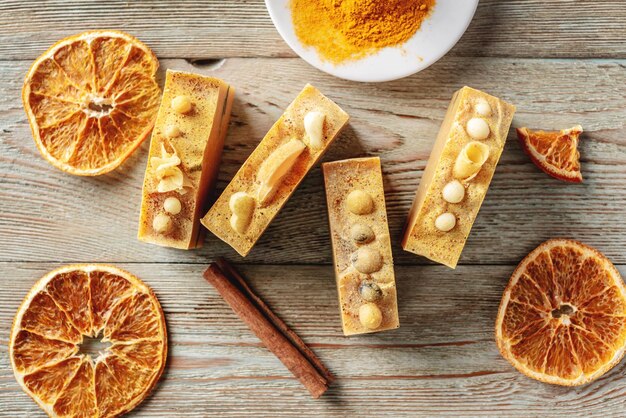 Natural orange soap on the wooden background Concept of making and using organic eco soap and cosmetics