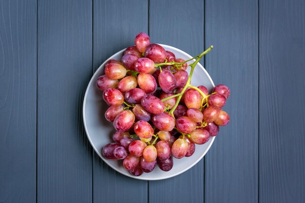 Natural organic black juicy grapes on trend dark gray surface  Top View Flat Lay 