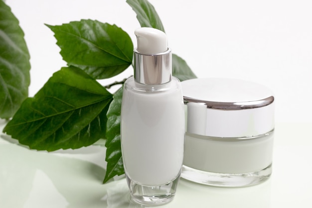 Natural organic cosmetics with green leaves. Blank label for mock branding