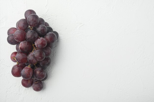 Natural organic juicy grapes set, dark red fruits, on white stone  background, top view flat lay, with copy space for text