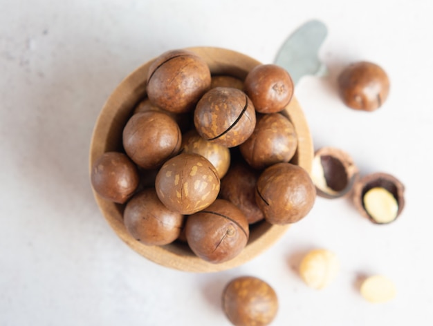 Natural organic macadamia nuts in a wooden bowl