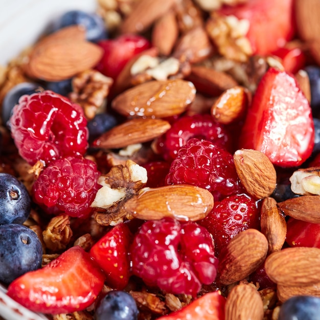 Natural organic raspberry strawberry blueberry nuts oat flax and honey are a healthy breakfast