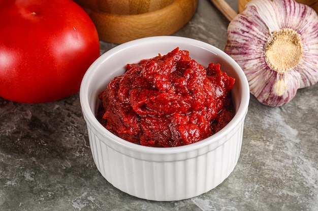 Natural organic red tomato paste in the bowl