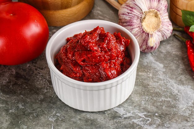 Natural organic red tomato paste in the bowl