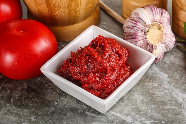 Natural organic red tomato paste in the bowl