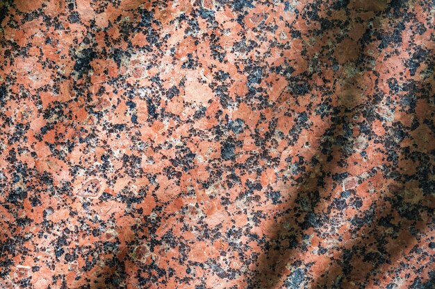 Natural pattern of polished red granite The texture and background of the stone