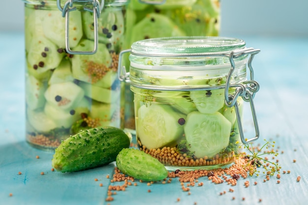 Natural pickled cucumber in jar with herbs