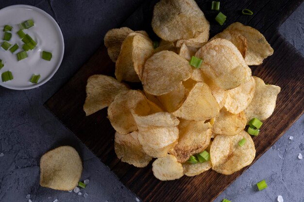 Natural potato chips on a gray concrete background