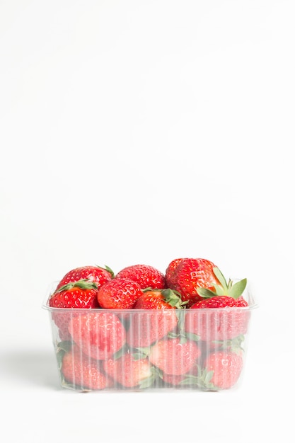 Natural red strawberries in a plastic transparent container