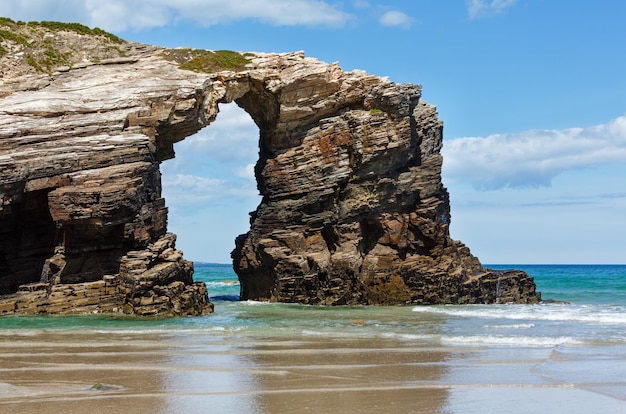 Natural rock arch on Cathedrals beach in low tide (Cantabric coast, Lugo (Galicia), Spain).