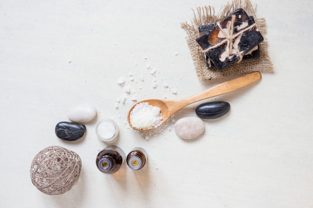 Photo natural sea salt and handmade soap with body oil on a white background spa concept. top wiev