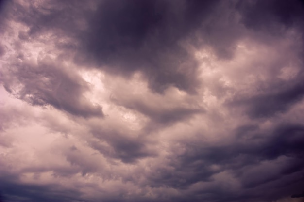 Natural sky composition. Dark ominous colorful storm rain clouds. Dramatic sky. Overcast stormy cloudscape. Thunderstorm. Element of apocalypse design. Toned.