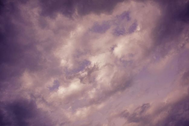 Natural sky composition. Dark ominous grey storm rain clouds. Dramatic sky. Overcast stormy cloudscape. Thunderstorm. Element of apocalypse design. Toned purple.