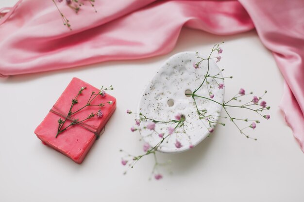 Natural soap bar with ceramic soap dish and flowers spa organic concept