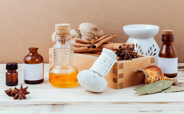 Natural Spa ingredients and bottle of essential oil on wooden background.