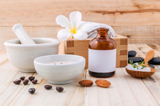 Natural Spa Ingredients and white mortar on wooden background .