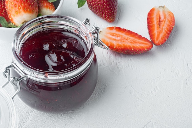 Natural strawberry jam jar on white