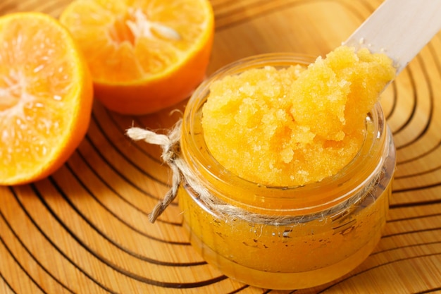 Natural sugar scrub with orange on wooden background