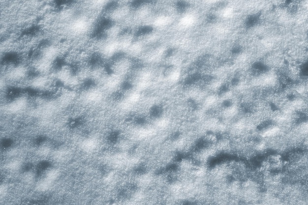 The natural texture of the uneven snow surface as a background for the design