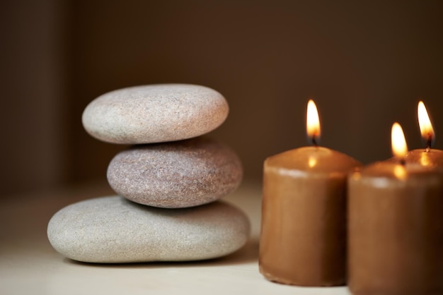 Natural therapy Three stones balanced on top of each other alongside some candles