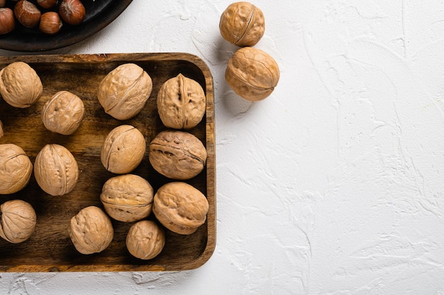 Natural walnut set on white stone table background top view flat lay with copy space for text