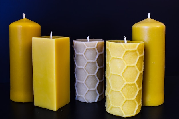 natural wax candles on a dark blue or black