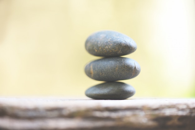 Natural wellness   Relax zen stones stack on wooden nature green  Spa Natural Alternative Therapy With Massage Stones