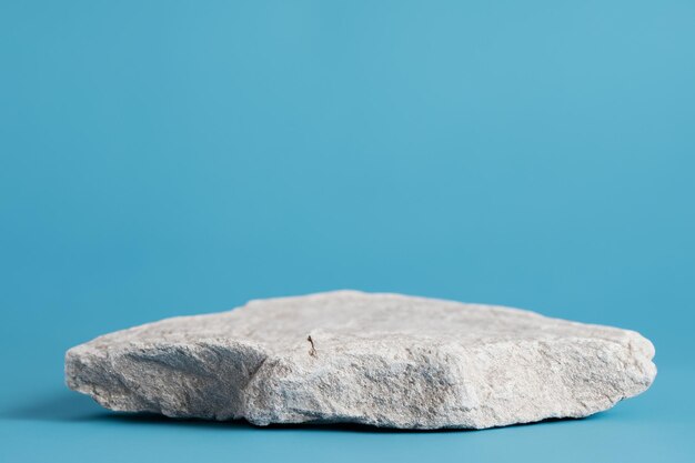 Natural white rock podium for product display with cyan blue background