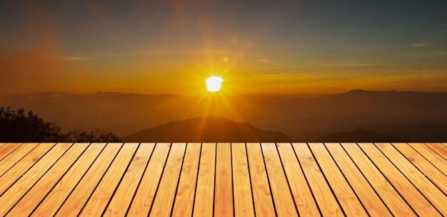 Natural wood floor and sunset over mountains