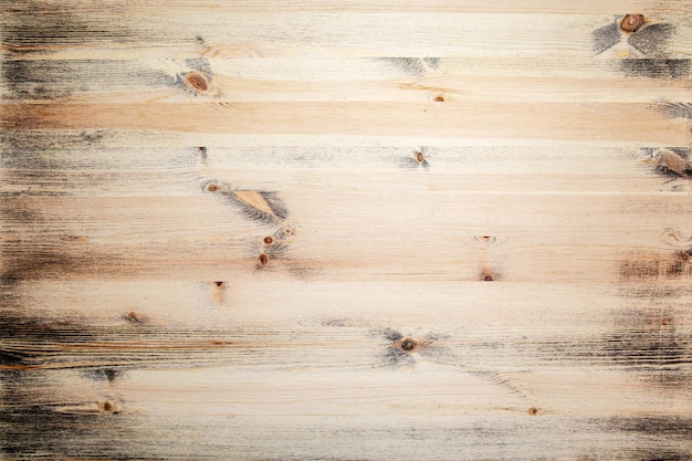 Natural wood surface with black paint residues