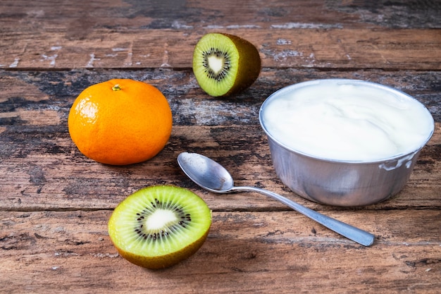  Natural yogurt and  fruit  on wooden table