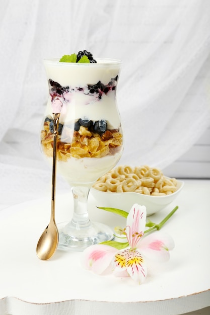 Natural yogurt with fresh berries on wooden table